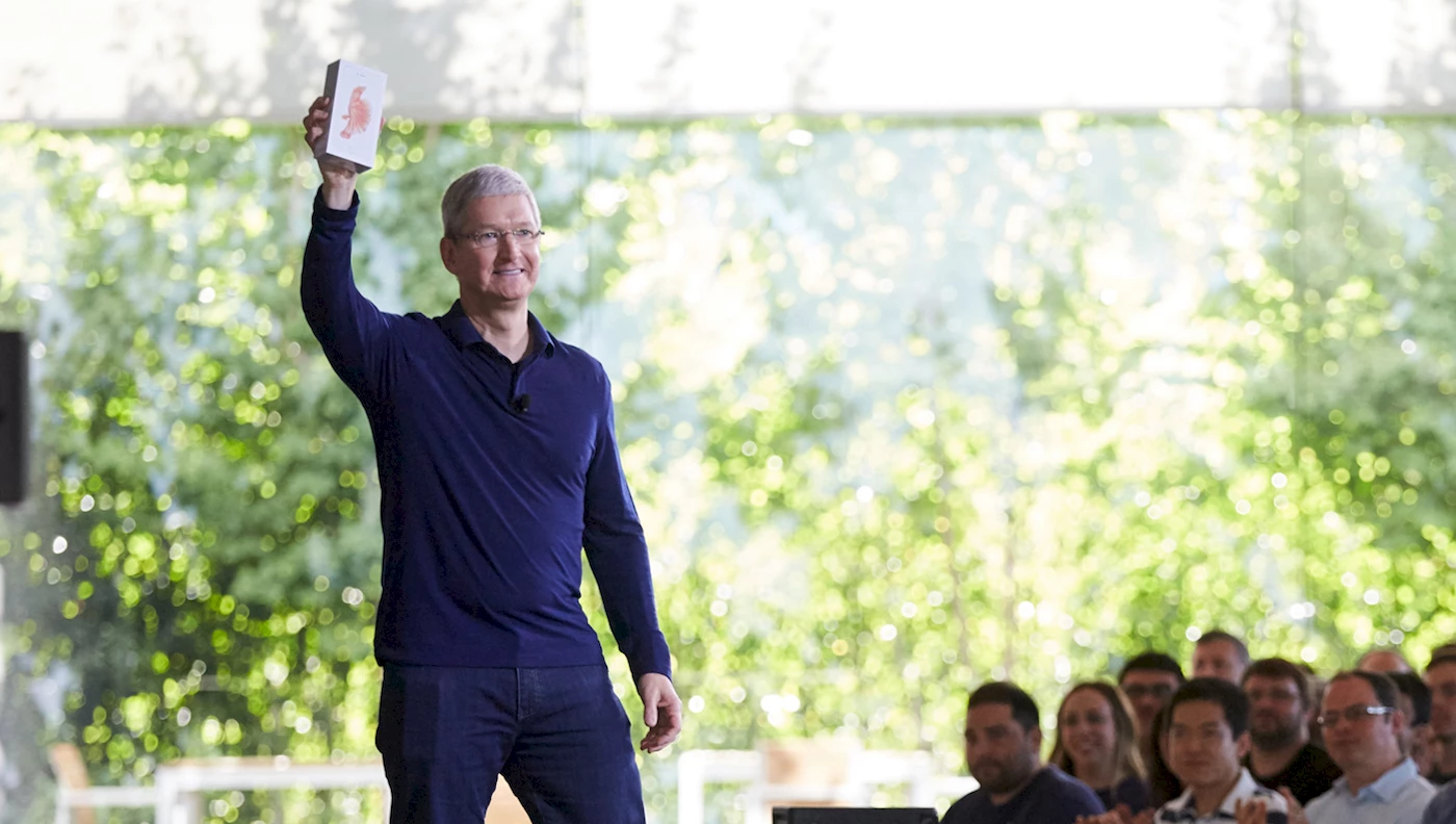 Tim Cook holds the billionth iPhone at an employee meeting in Cupertino. Photo Apple.