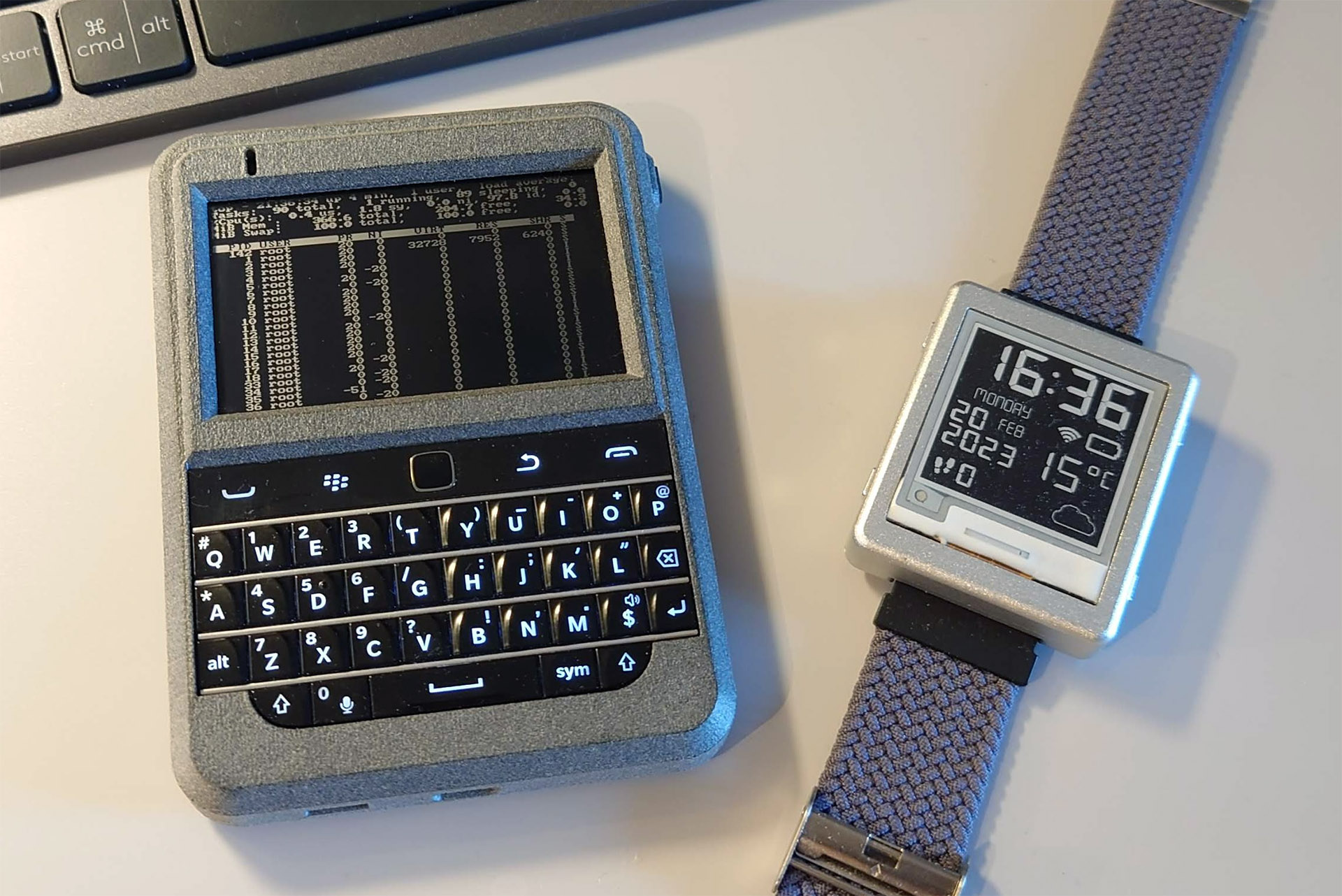 A Beepberry with a 3D-printed shell next to a ‘Watchy’ smartwatch.