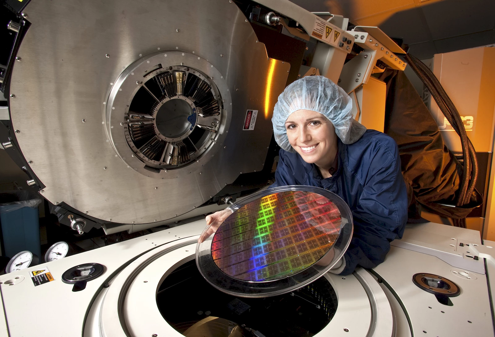 IBM Test Engineer Sara Lestage holds a 300mm Power 7 processor wafer, 2010.