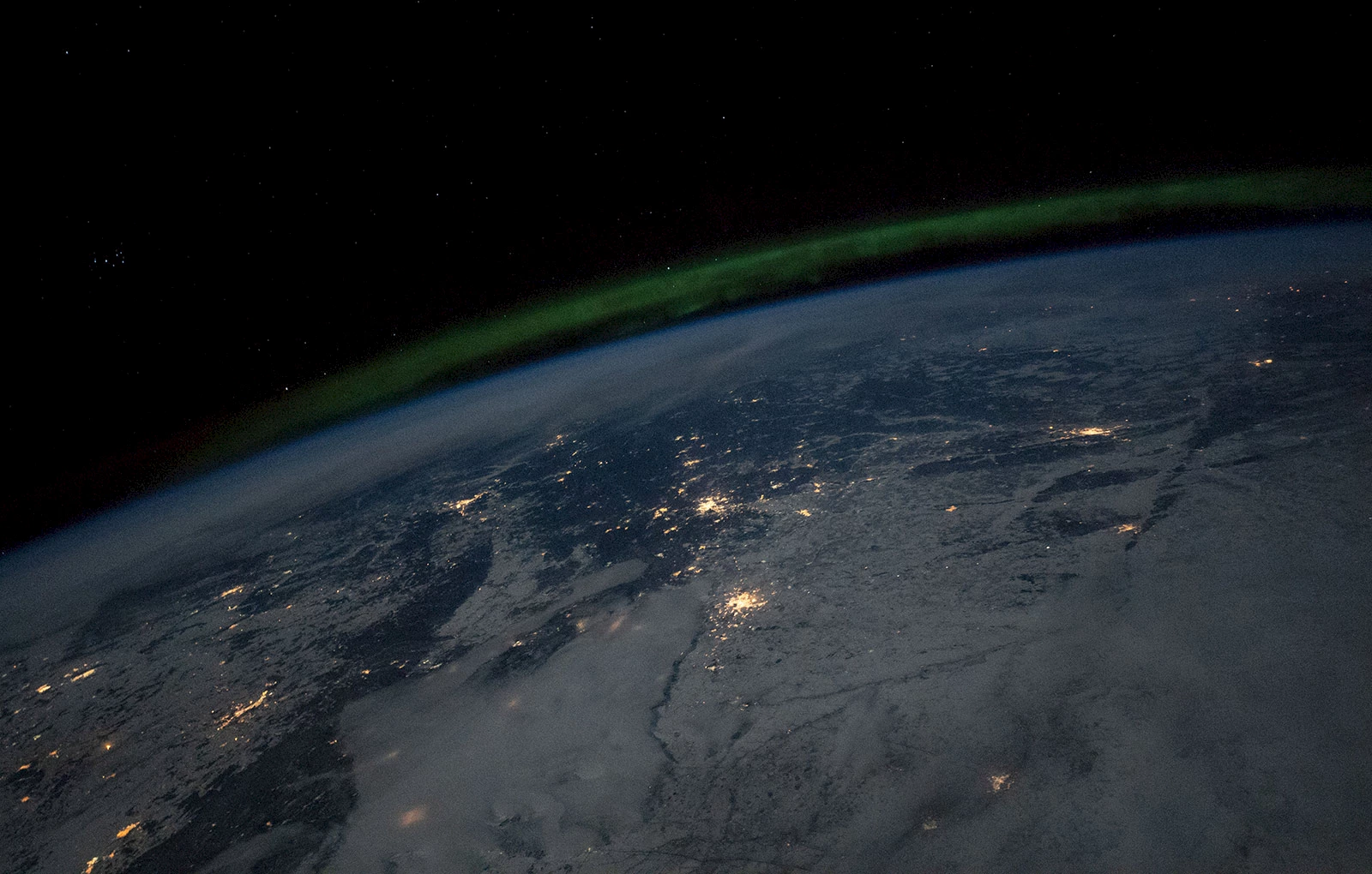 City lights and the aurora from the International Space Station, 412 km above Russia and Kazakhstan. March 19, 2019.
