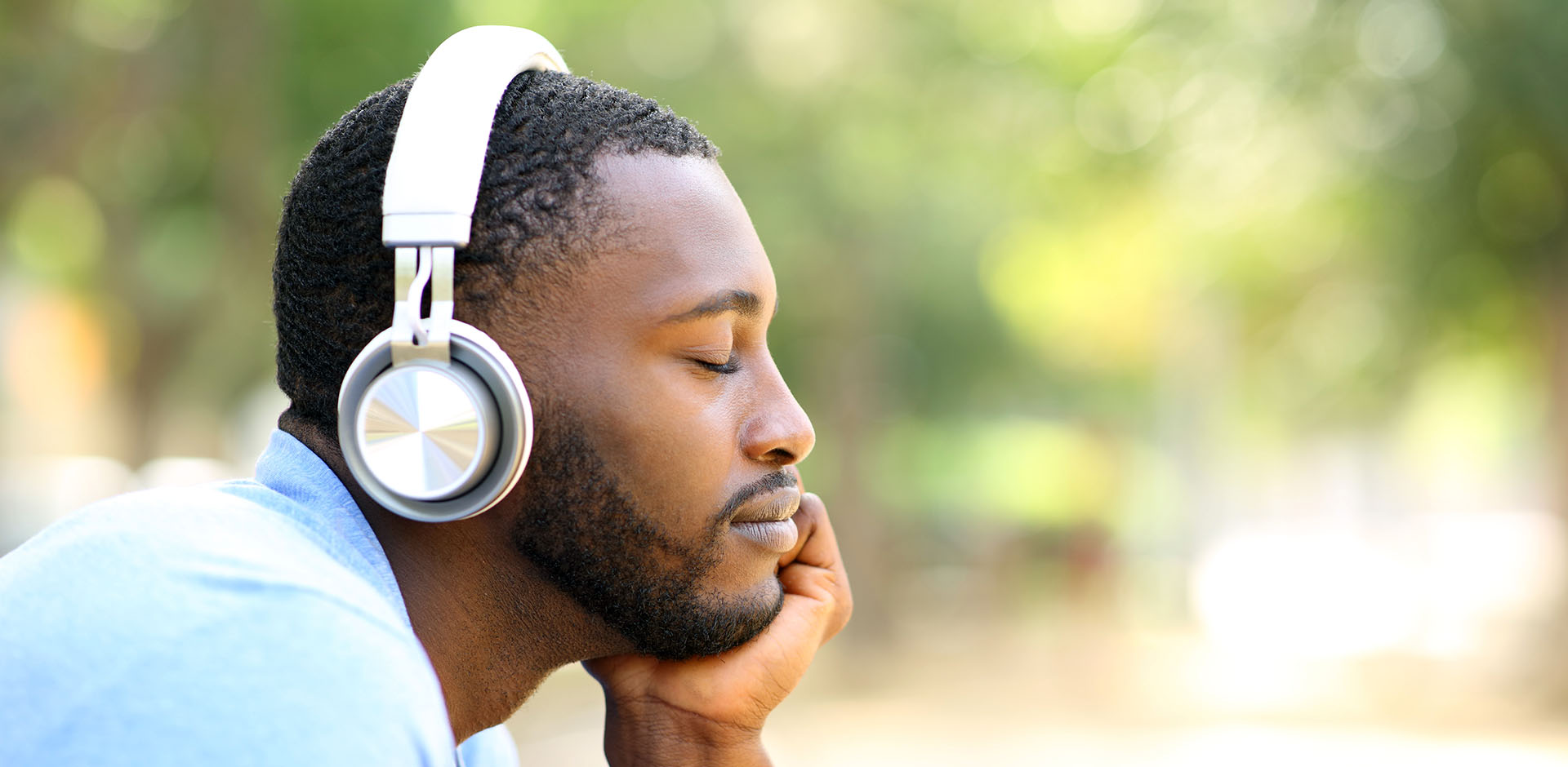 Man listening to music in a park.
